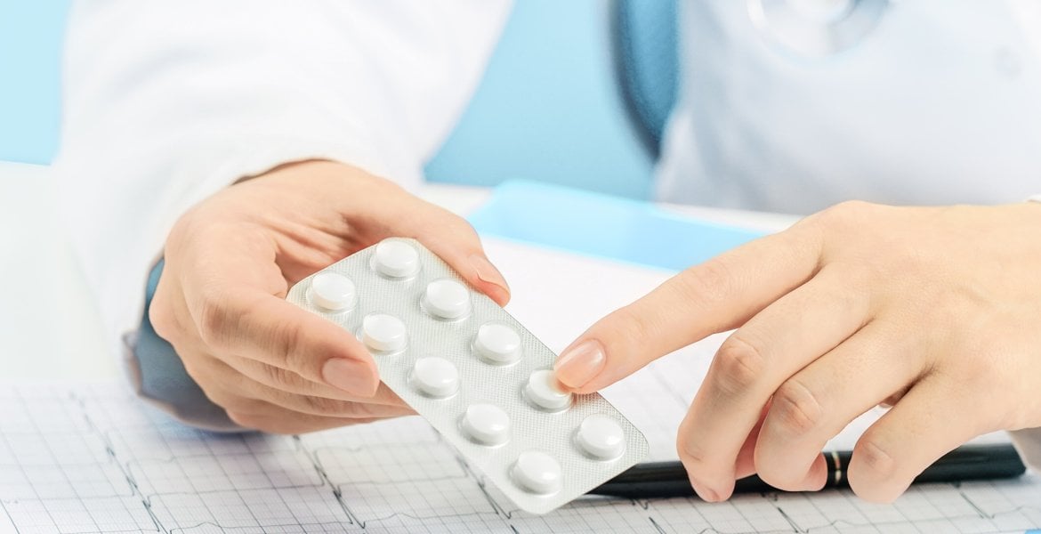 Ärztin hält eine Packung Cotrimoxazol-Tabletten