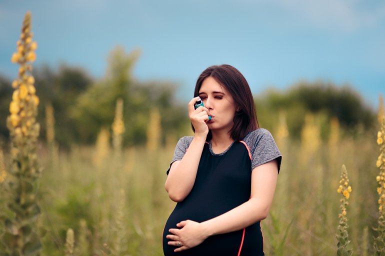 Schwangere Frau mit Asthma-Spray